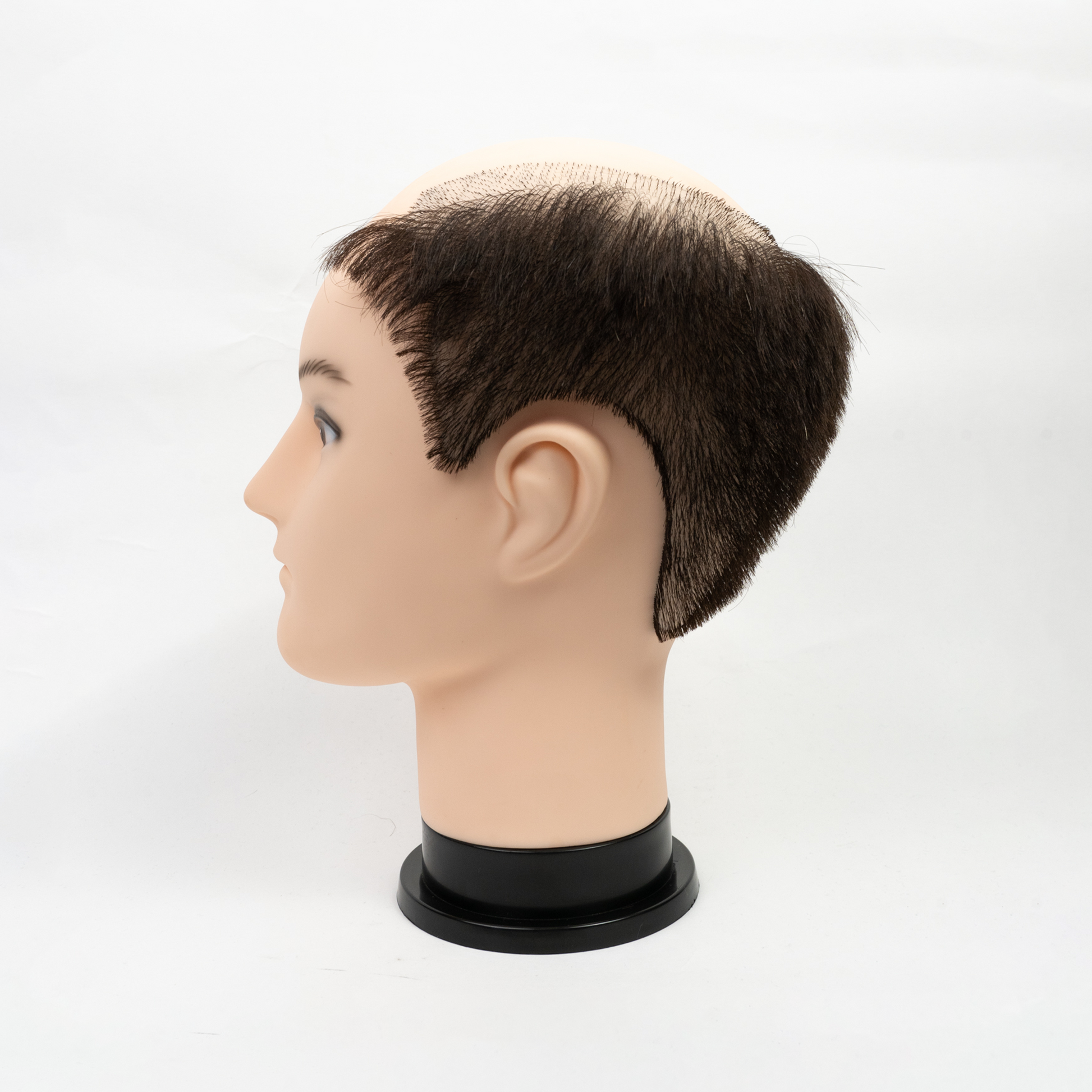 Female mannequin head with long blonde hair and blue eyes