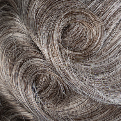 A close-up image of a lace hair system with medium density strands