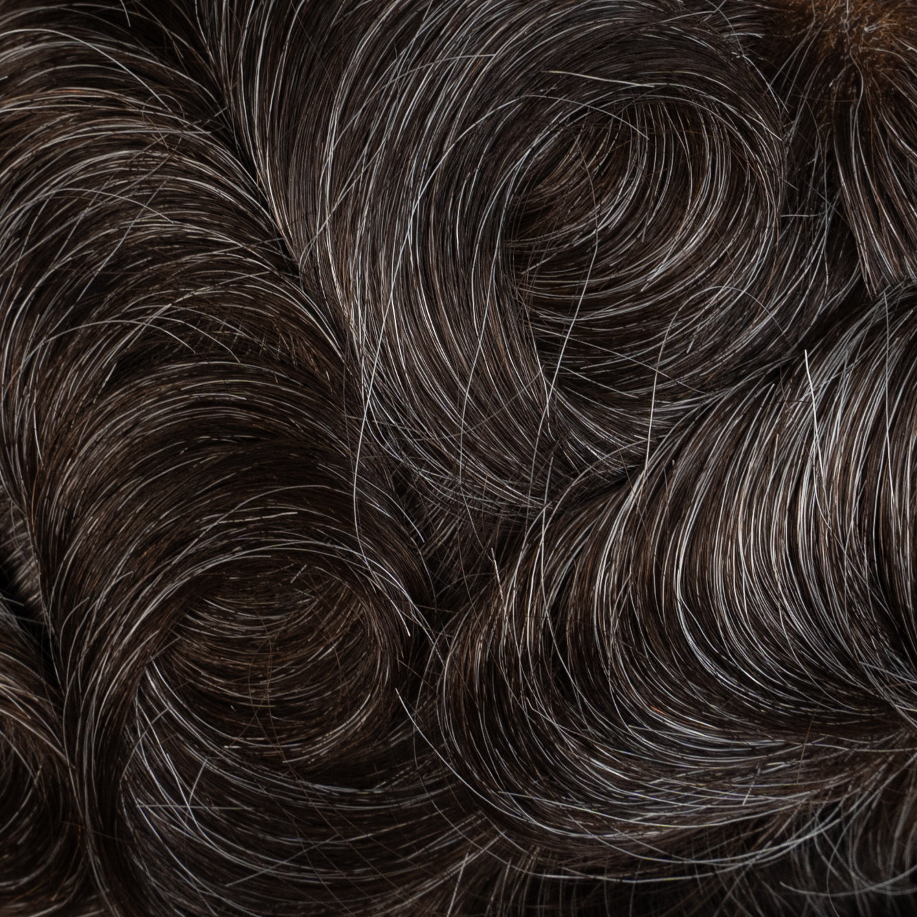 A close-up image of a lace hair system with medium density, designed to provide natural-looking and voluminous hair for individuals with hair loss or thinning