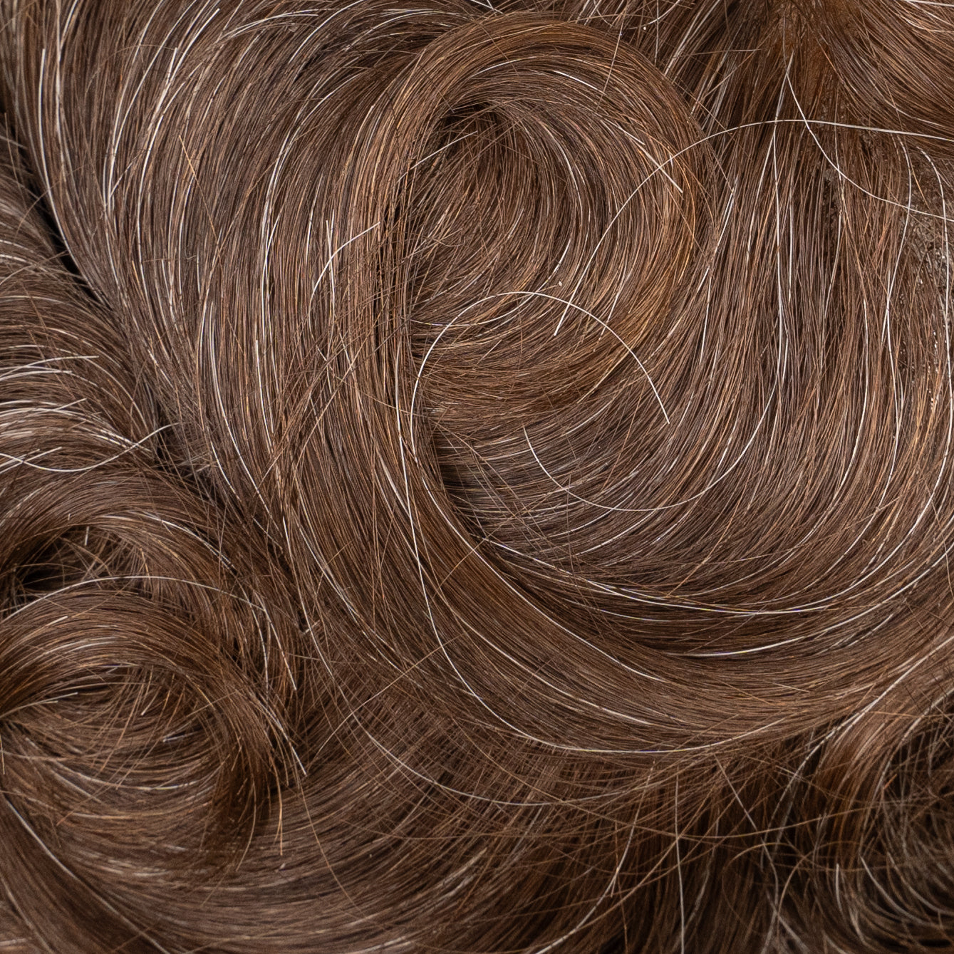 A close-up image of a medium density lace hair system for natural-looking hair